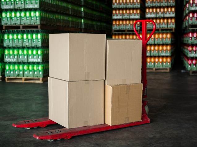 Cardboard boxes on trolley in juice factory